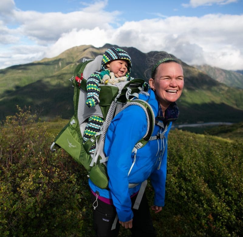 Woman in mounatains with baby in pack