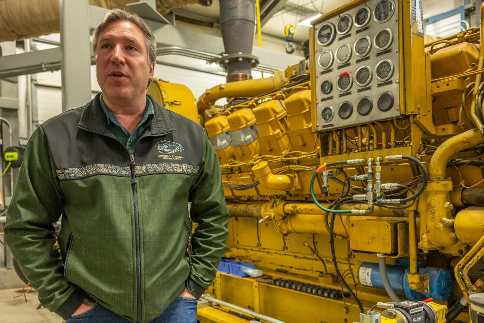 A man standing next to an engine.