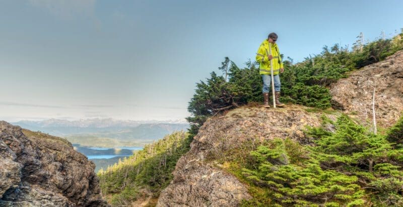 Man standing on a cliff top.